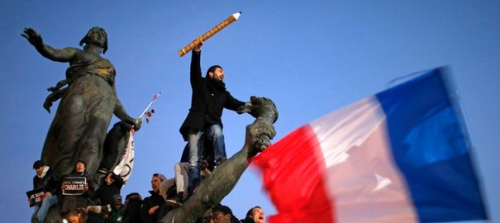 a-man-holds-a-giant-pencil-as-he-takes-part-in-a-hundreds-of-thousands-of-french-citizens-solidarity-march-marche-republicaine-in-the-streets-of-paris_5185477.jpg