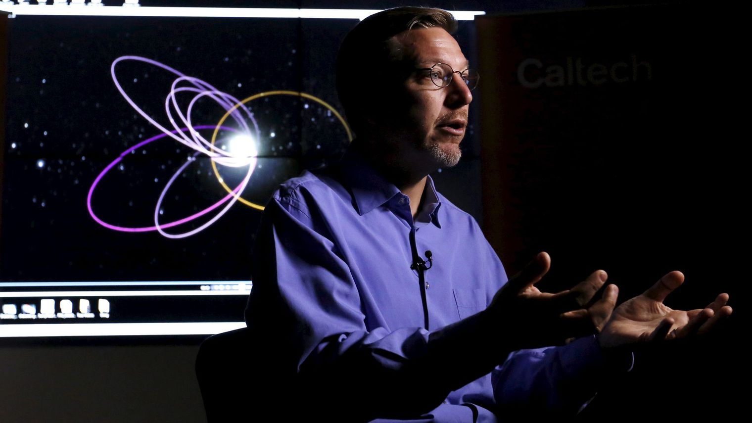 professor-of-planetary-astronomy-mike-brown-speaks-in-front-of-a-computer-simulation-of-the-probable-orbit-of-planet-nine-at-the-california-institute-of-technology-in-pasadena-california_5501427.jpg