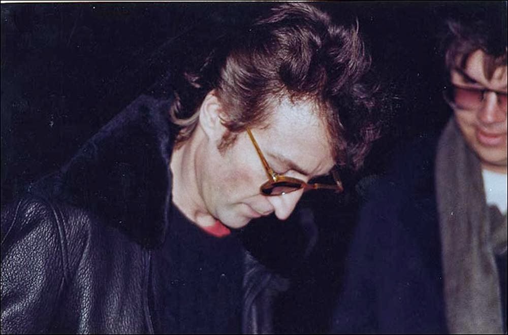 John-Lennon-signs-an-autograph-for-Mark-Chapman-his-murderer-December-8-1980.jpg