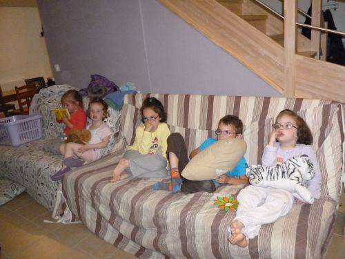 Les enfants avec leurs copains, crevés devant la télé, en attendant les burgers maison