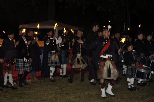 La KSF (Kilt Society de France) entourant les pipes band avec leurs flambeaux