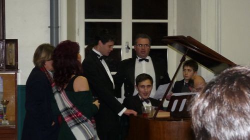 The director and junior faculty, singing