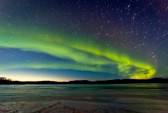 19939566-intense-northern-lights-or-aurora-borealis-or-polar-lights-and-morning-dawn-on-night-sky-over-icy-la.jpg