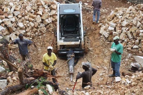 L'équipe haïtienne qui creusent pour le réservoir d'eau. - The Haitian team digging a whole for the water tank.