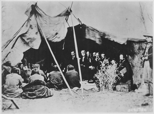 Photograph_of_General_William_T._Sherman_and_Commissioners_in_Council_with_Indian_Chiefs_at_Fort_Laramie_Wyoming_ca._1_-_NARA_-_531079.jpg