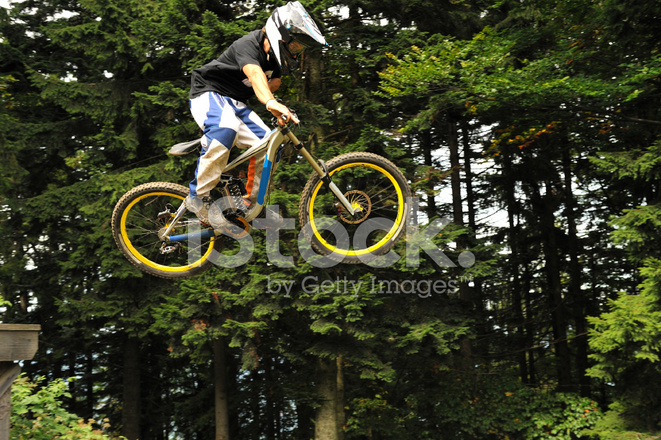 14336425-mountain-biker-at-downhill-jump.jpg