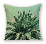 Un coussin avec des motifs de palmiers